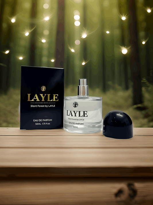 Layle perfume bottle and packaging on a wooden surface with a forest background
