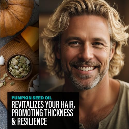Man with blonde hair and beard smiling, with pumpkin seeds and pumpkin pieces on a wooden surface.