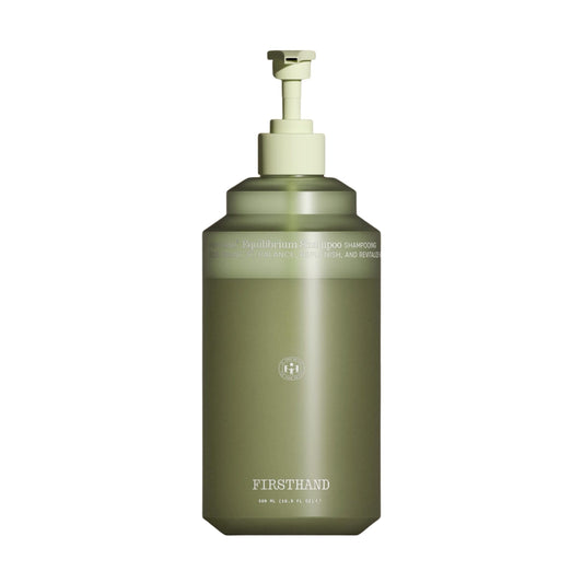 Green bottle with pump dispenser on a white background