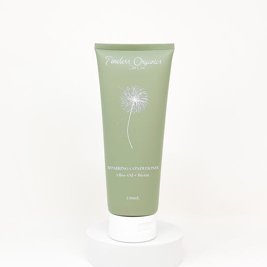 Green tube of Timbers Organics repairing conditioner on a white background