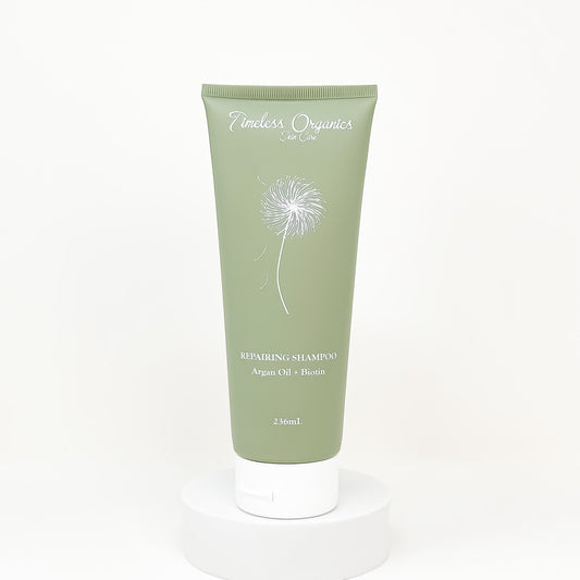 Green shampoo tube with phoenix design on a white background
