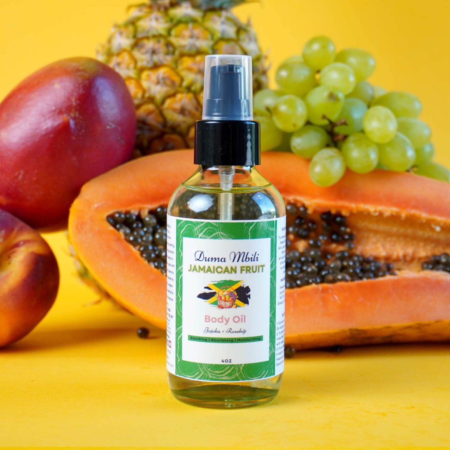 Bottle of Jamaican Fruit Body Oil with fruits on a yellow background